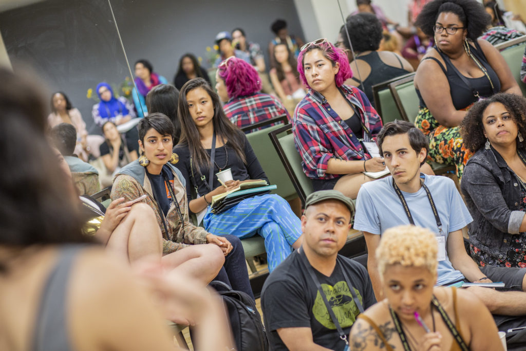 AMCers seated and engaged in front of a speaker