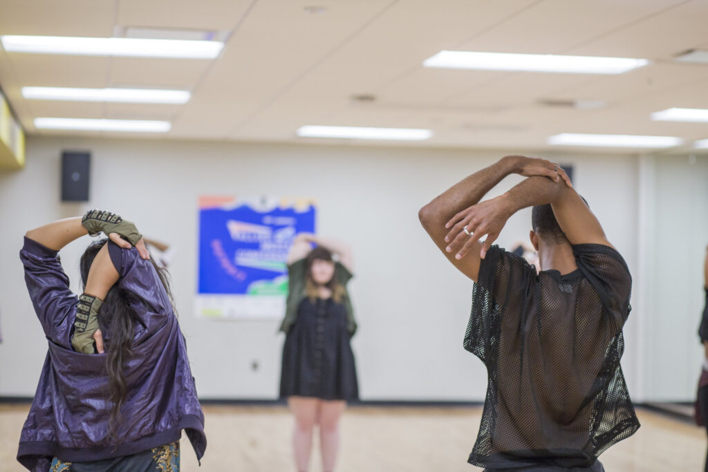 Three AMCers doing a shoulder stretch