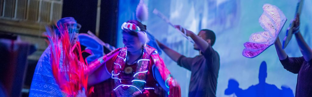 Photo of an Anishinaabe woman dancing in her traditional regalia.