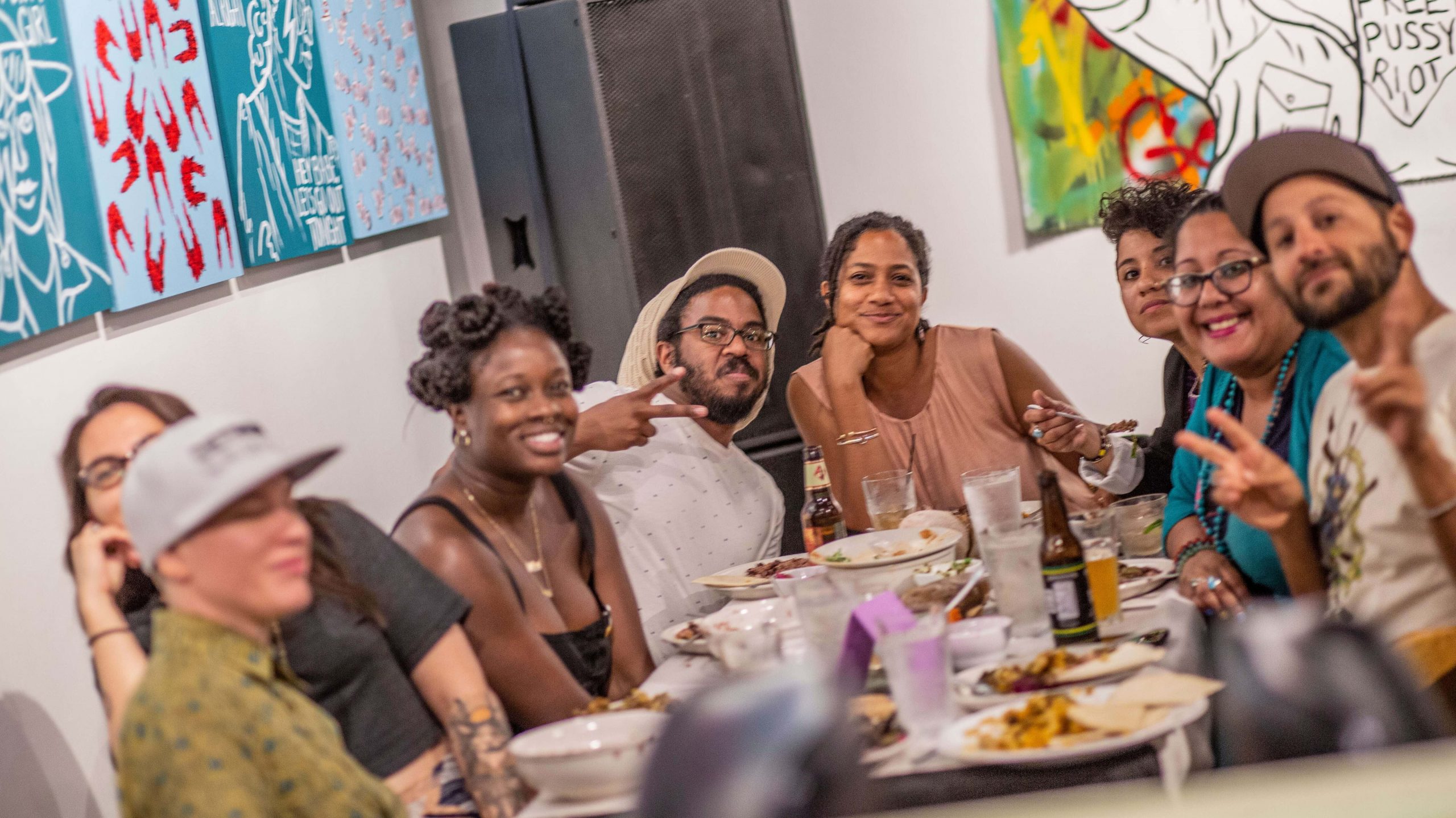 A grou of young activists sit around a table of food